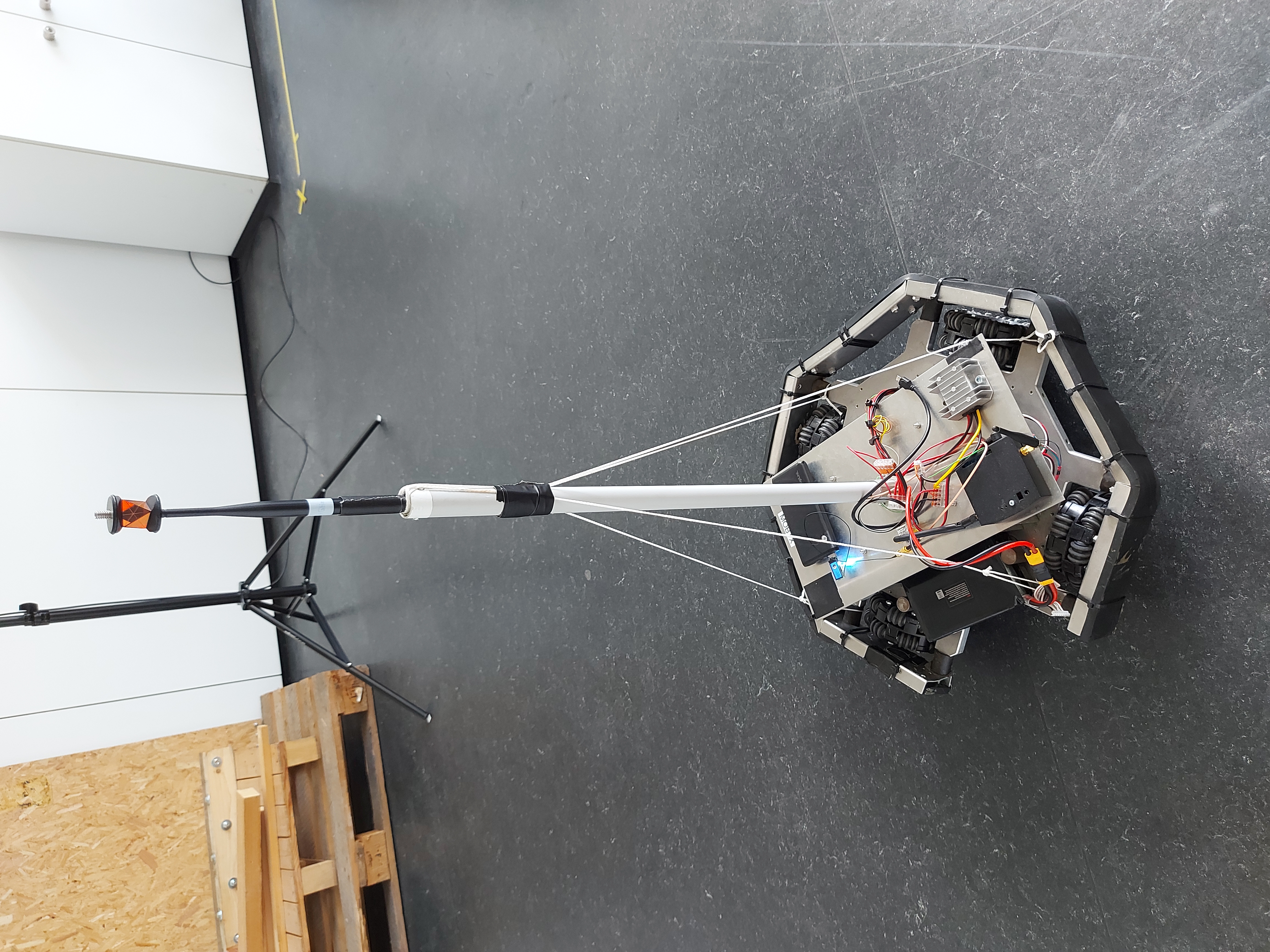 Robot carrying the transmitter seen from the side, with antenna and prism used for tracking the antenna.